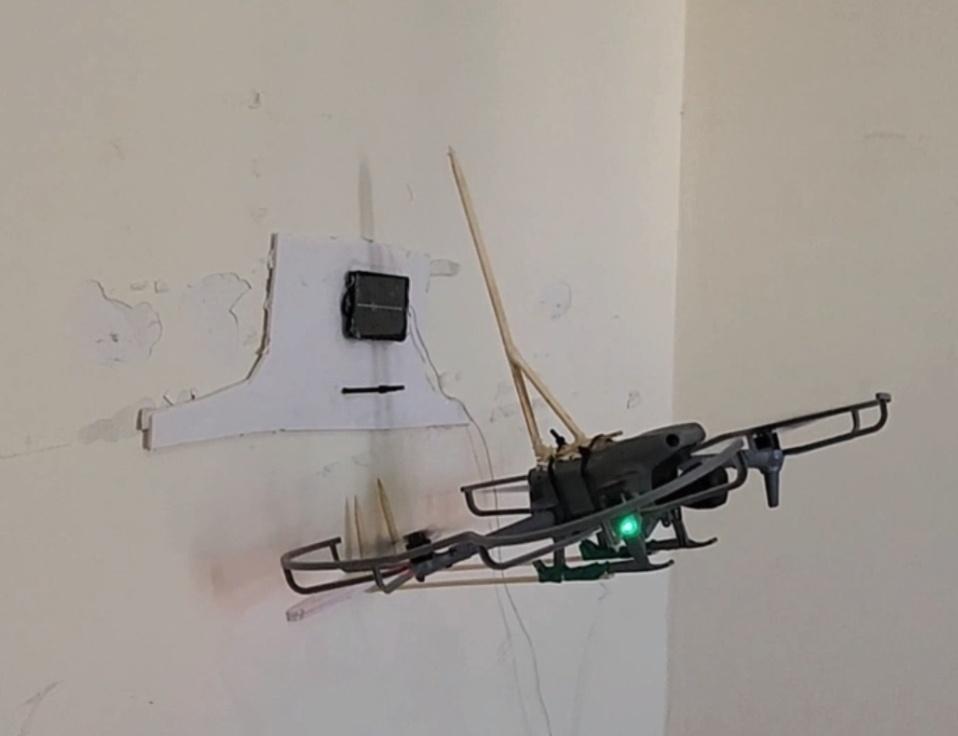 7_DroneAttachDeviceToWall.jpg