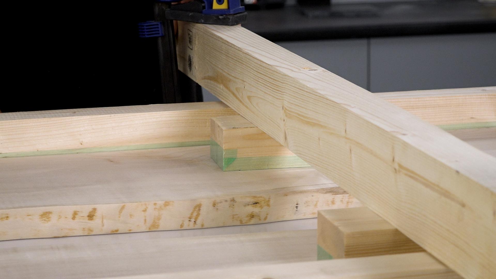 Applying clamps to bridging timber.jpg