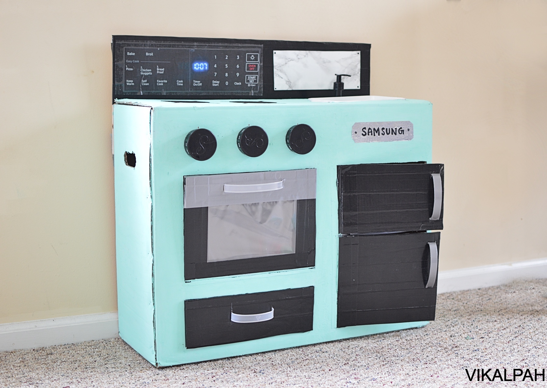 DIY Cardboard kids play kitchen with drawer oven fridge twisting knobs sink fridge.jpg