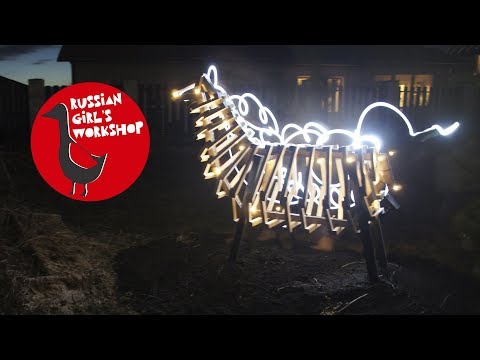 Garden sculpture of wood with LED lighting on a solar panel