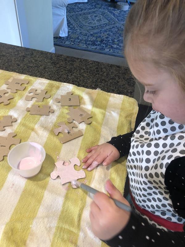 Harper painting the puzzle pieces.JPG