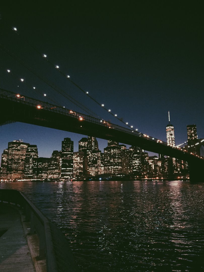 New York at Night through the Brooklyn Bridge.jpg