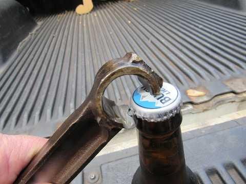 Piston rod bottle opener
