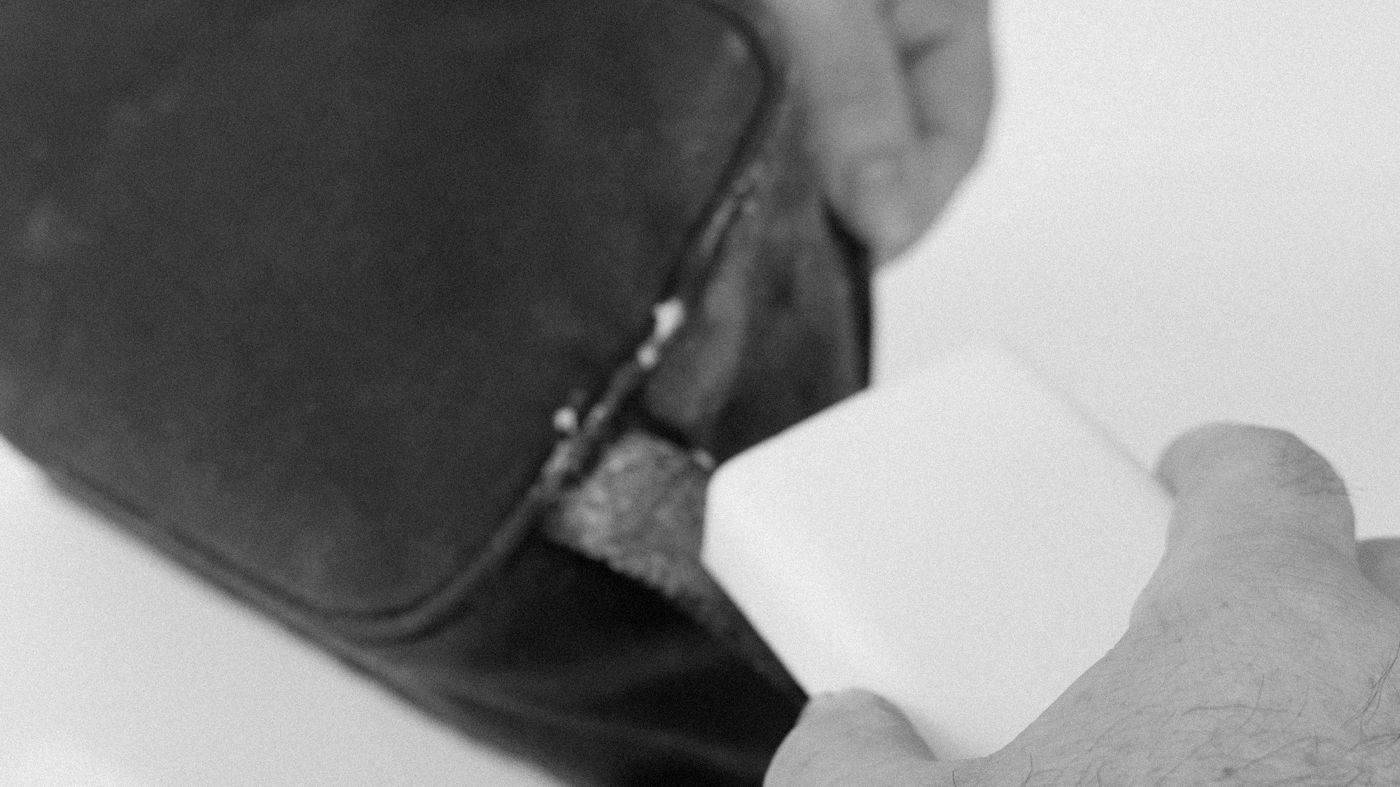 Rubbing-Fabric-Wax-into-Bag-Black-and-White.png