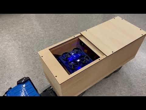 The mini drone is flying from the wooden container of the truck