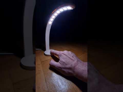 Tiny wood lamp is turned on, brightness is changed and turned off again