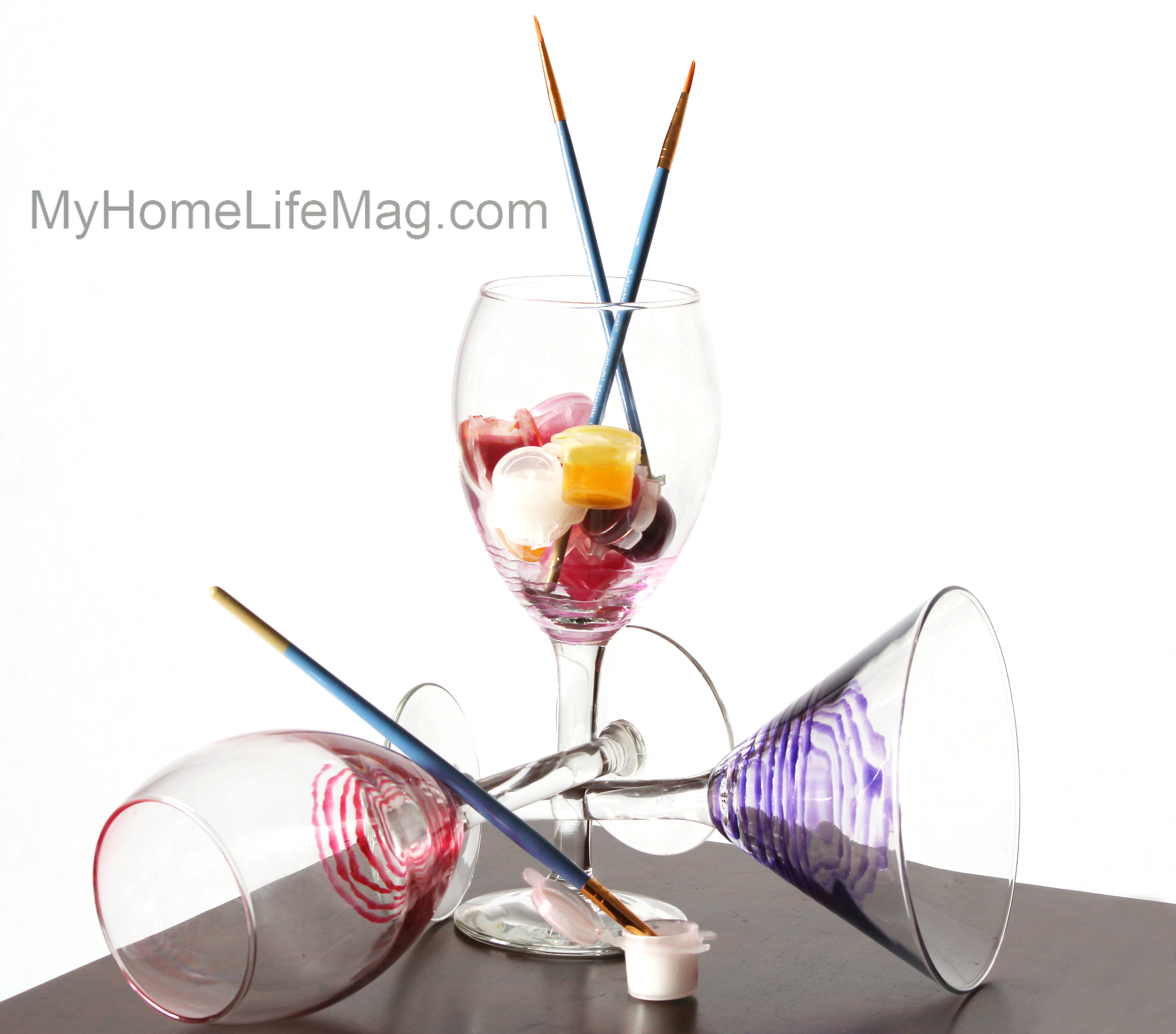 Use glass paint and add swirls to the bottom of a set of wine glasses - MyHomeLifeMag.jpg