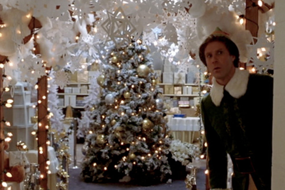 buddy the elf decorating the store with snowflakes.jpg