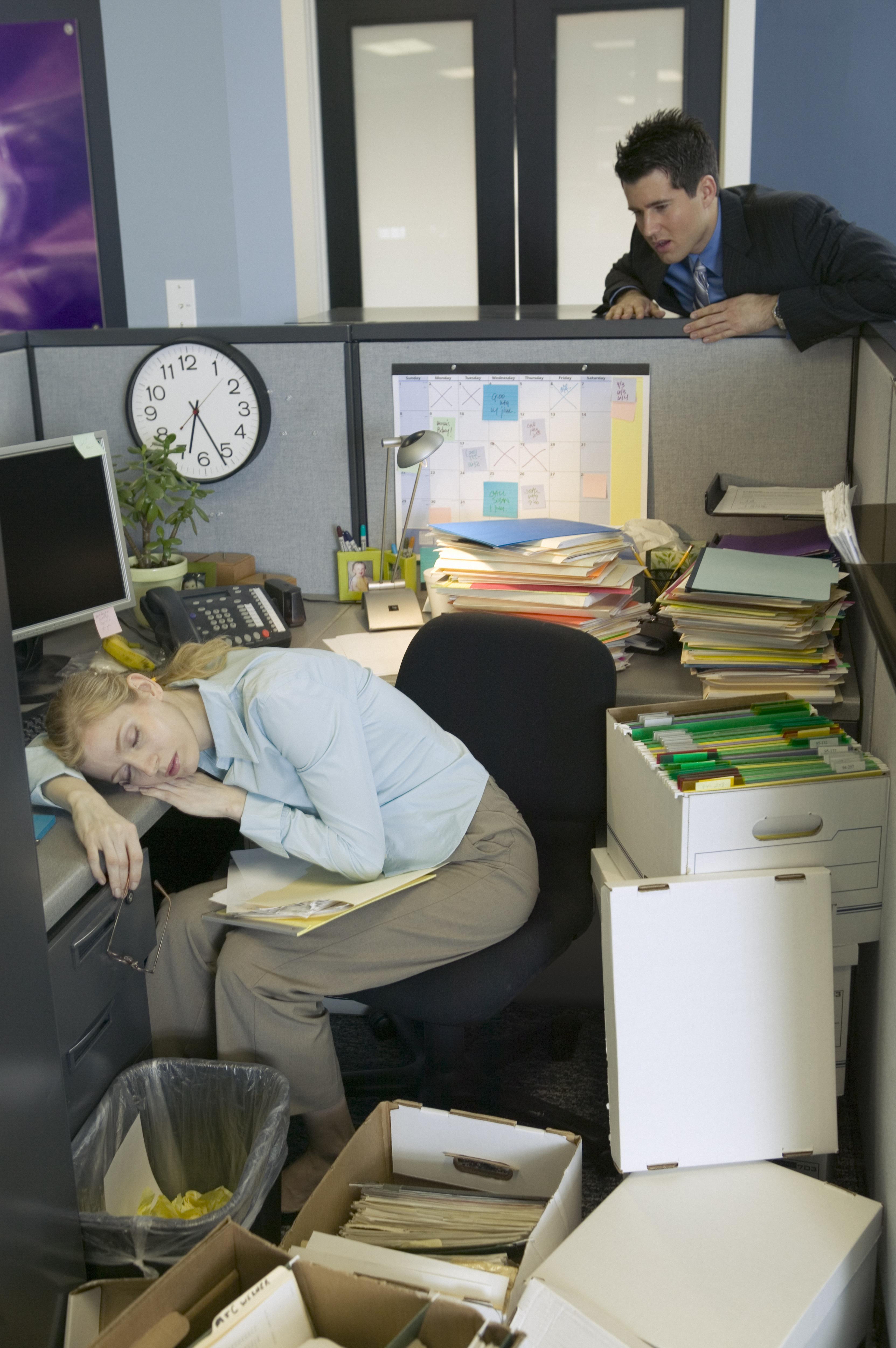 businessman-watching-businesswoman-sleeping-in-cubicle-2291847.jpg