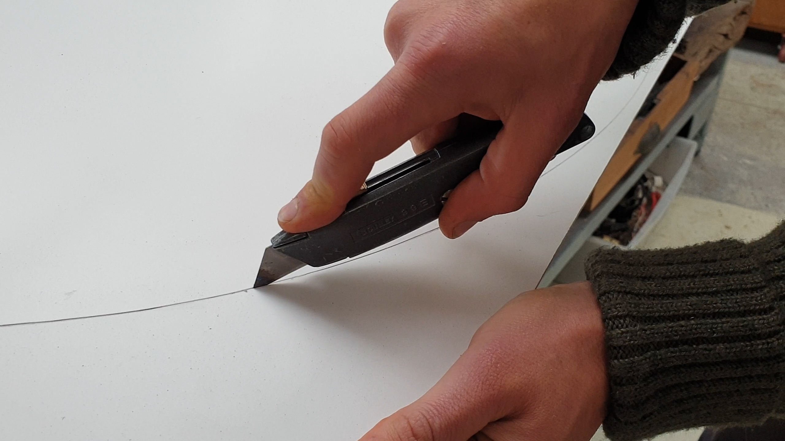 cutting plastic card with knife.jpg