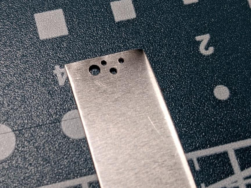 drilled_holes_in_metal_sheet.jpg