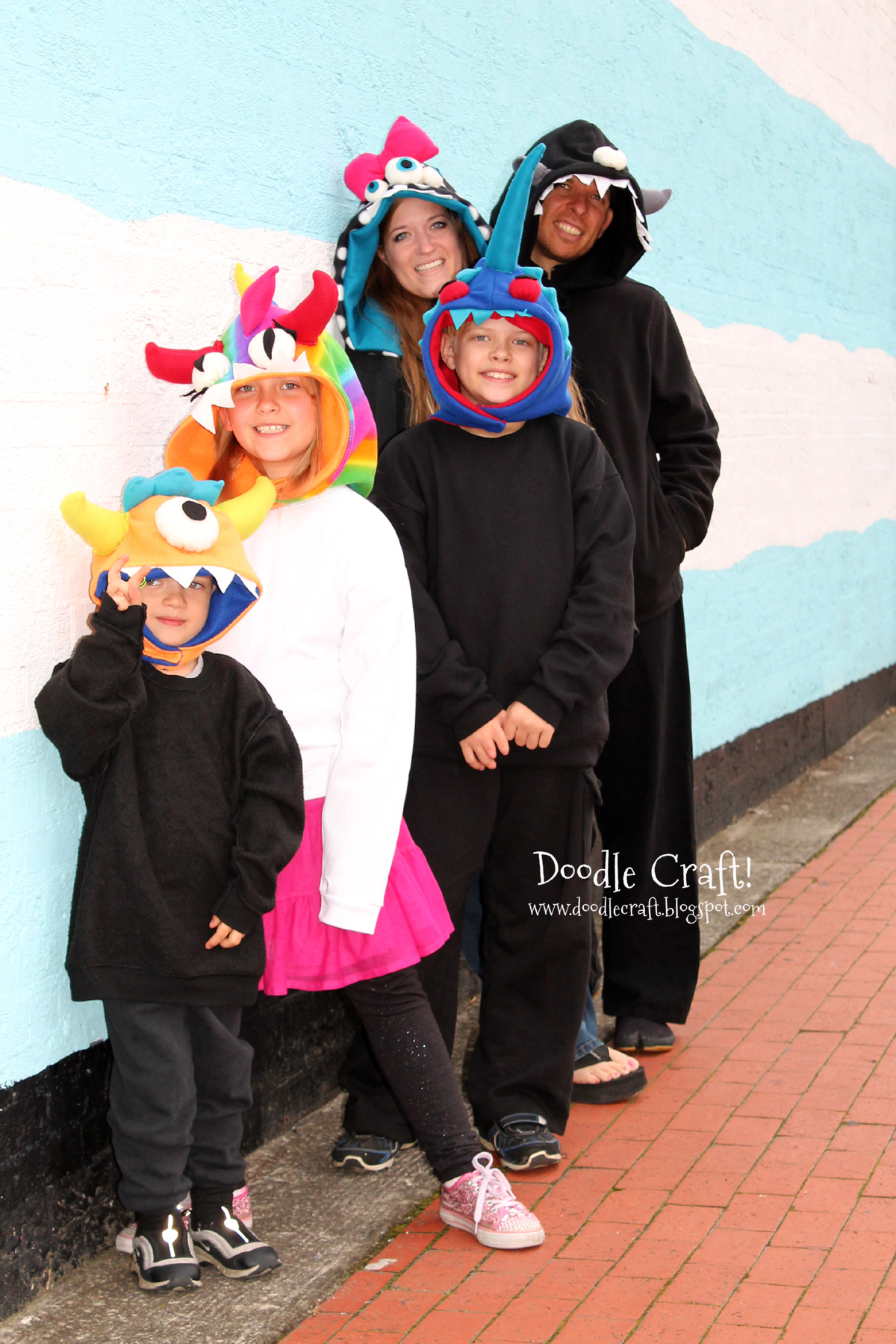 family pic against painted brick wall blue and white.jpg