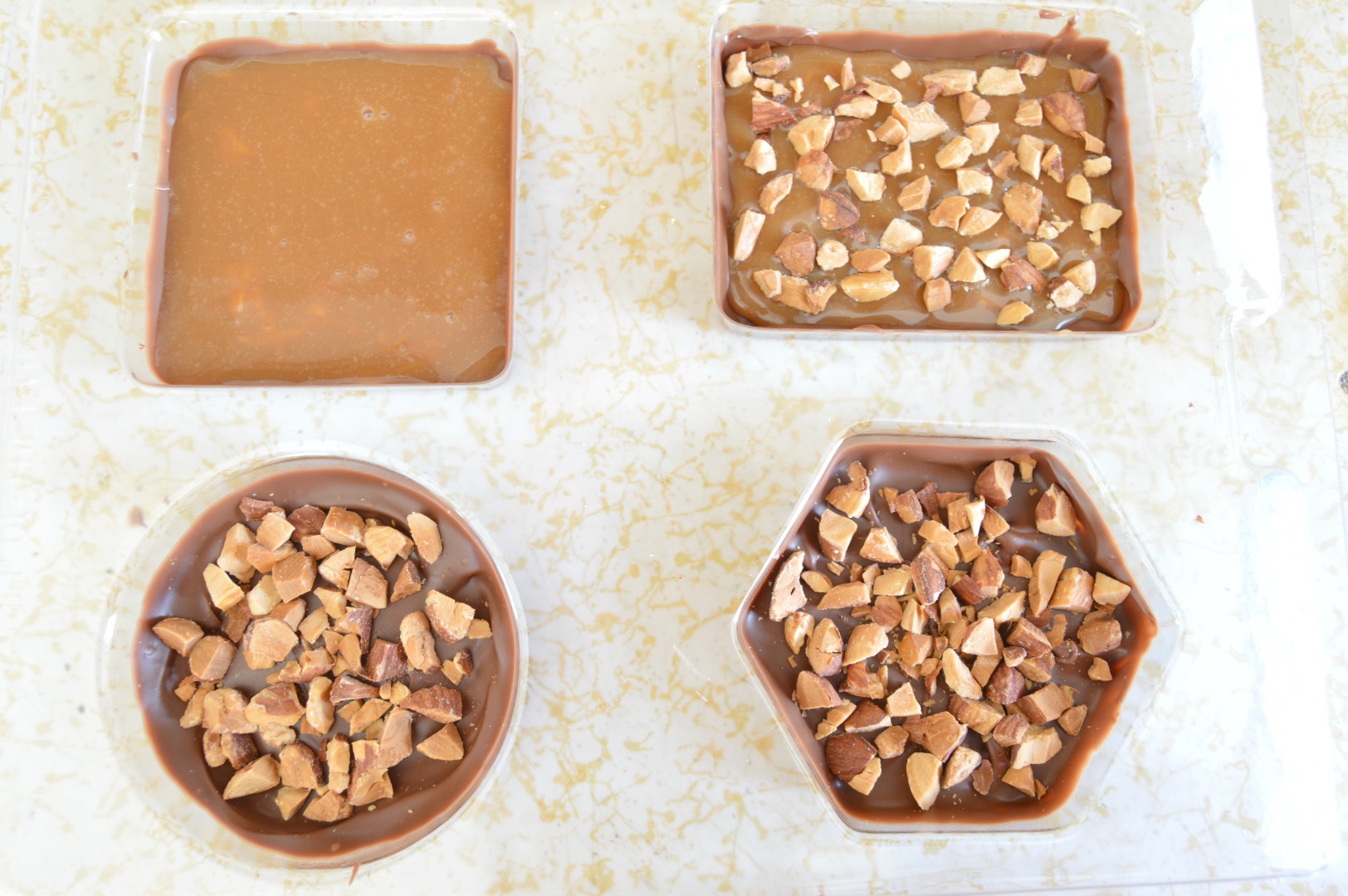 fill up the molds with almonds and caramel.jpg