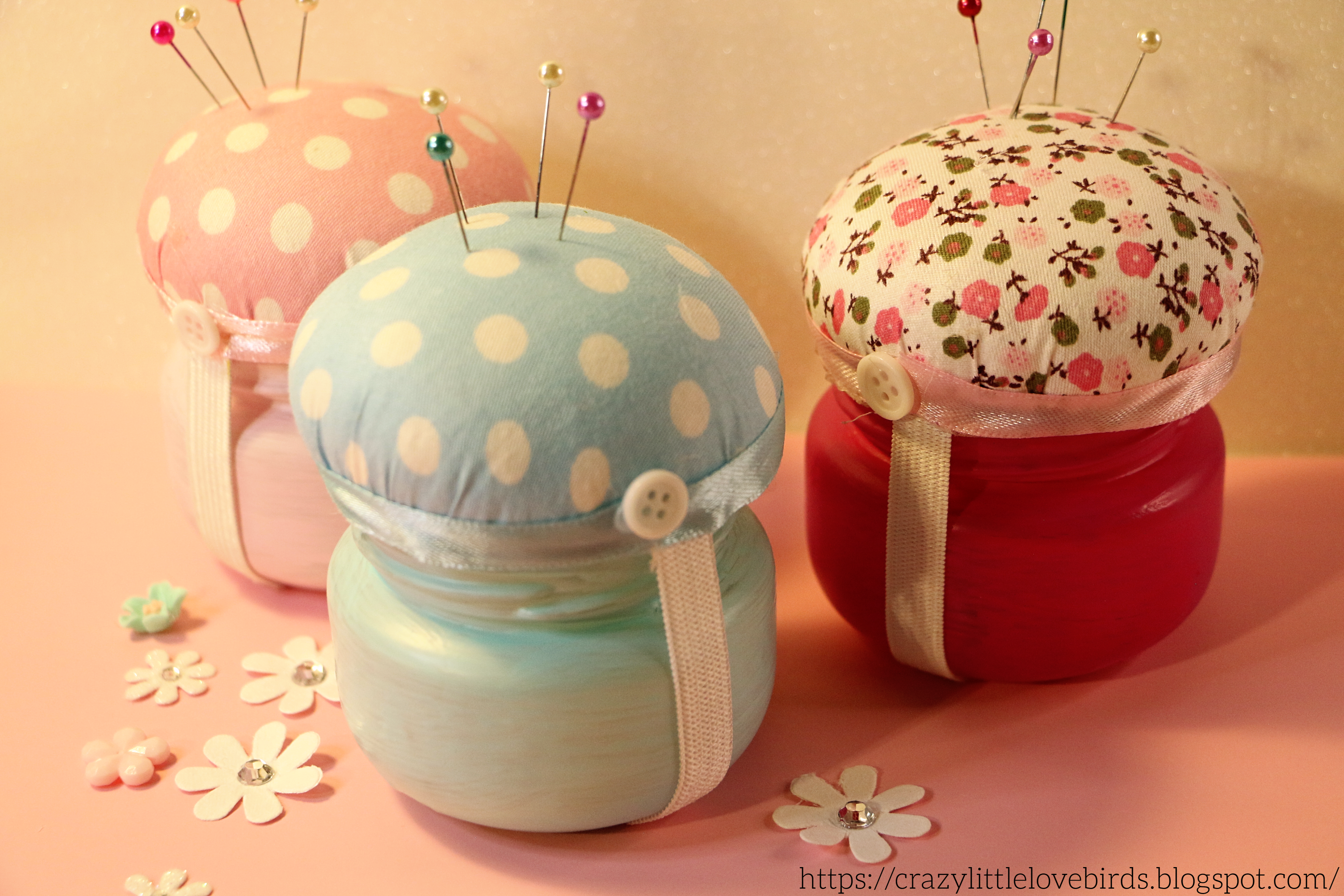 glass jars with pin cushions.png