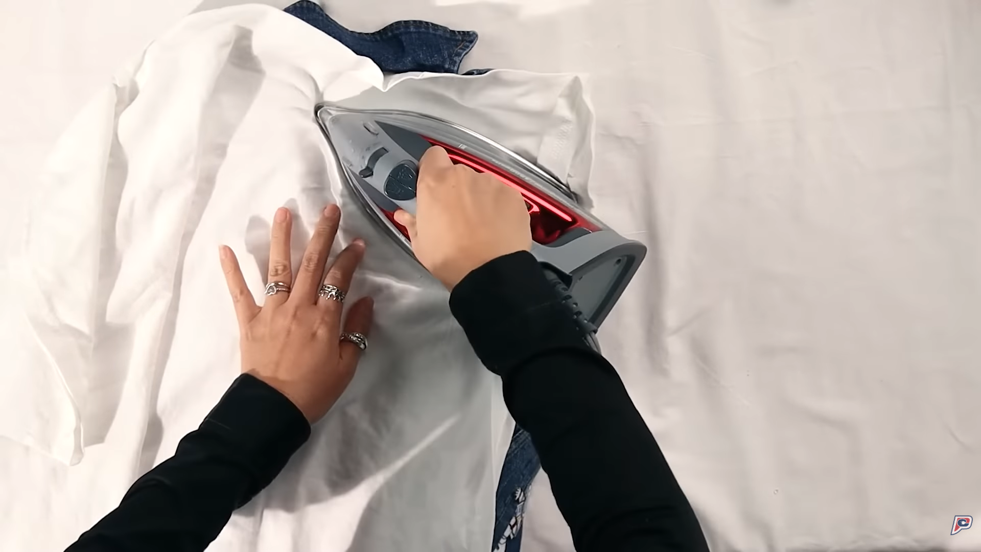 hands ironing the inside of the jacket.png