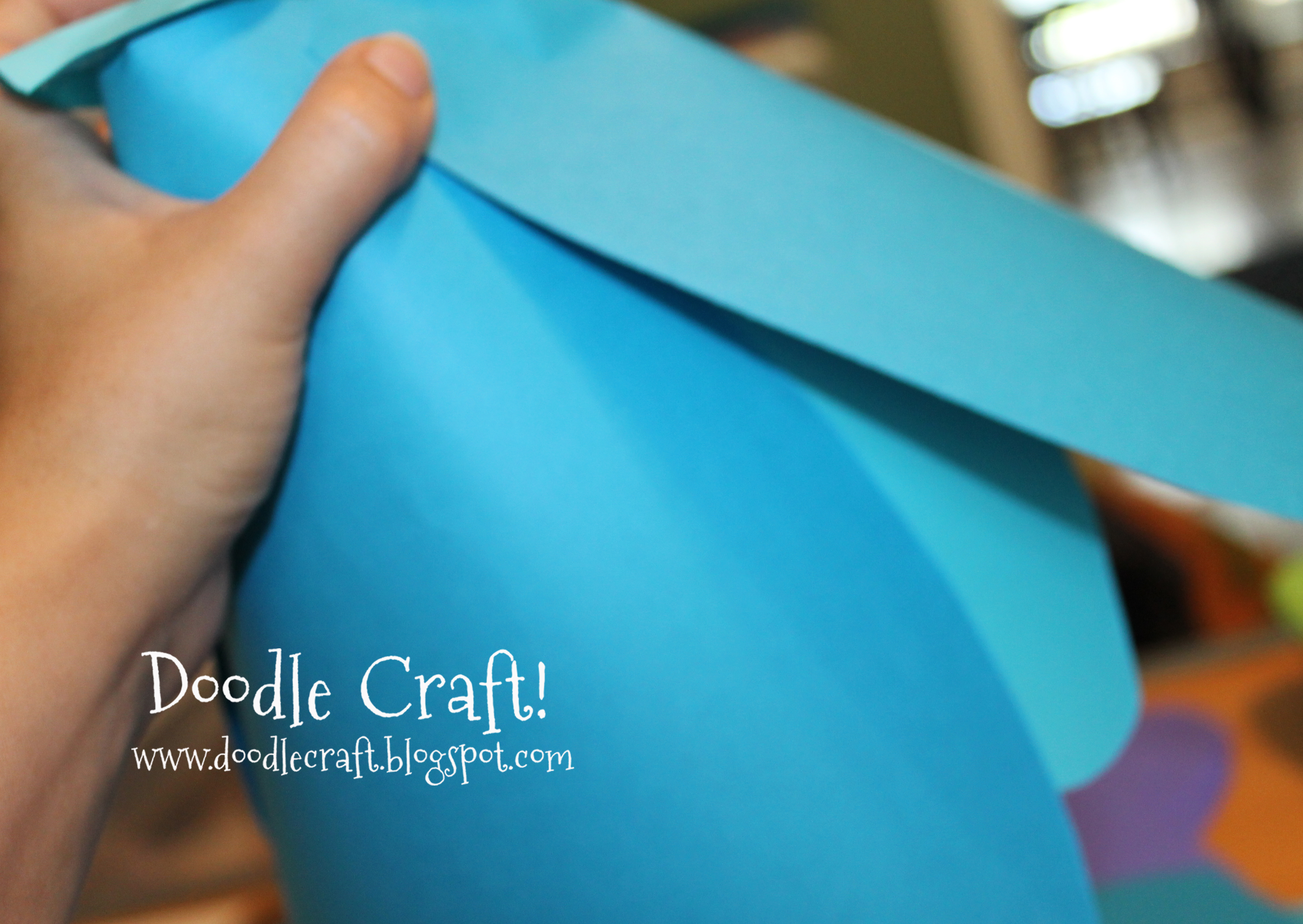 holding giant paper flowers.jpg