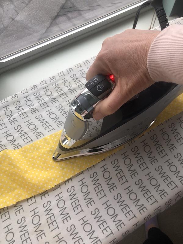 ironing the vinyl onto foam sheet.JPG