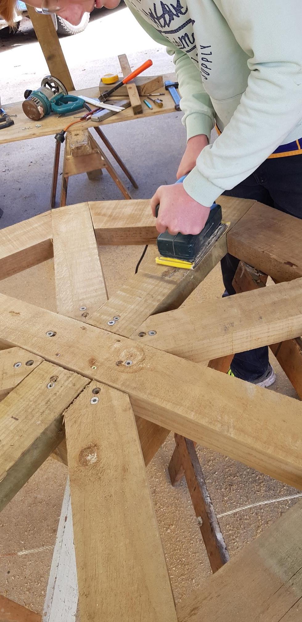 sanding the water wheel.jpg