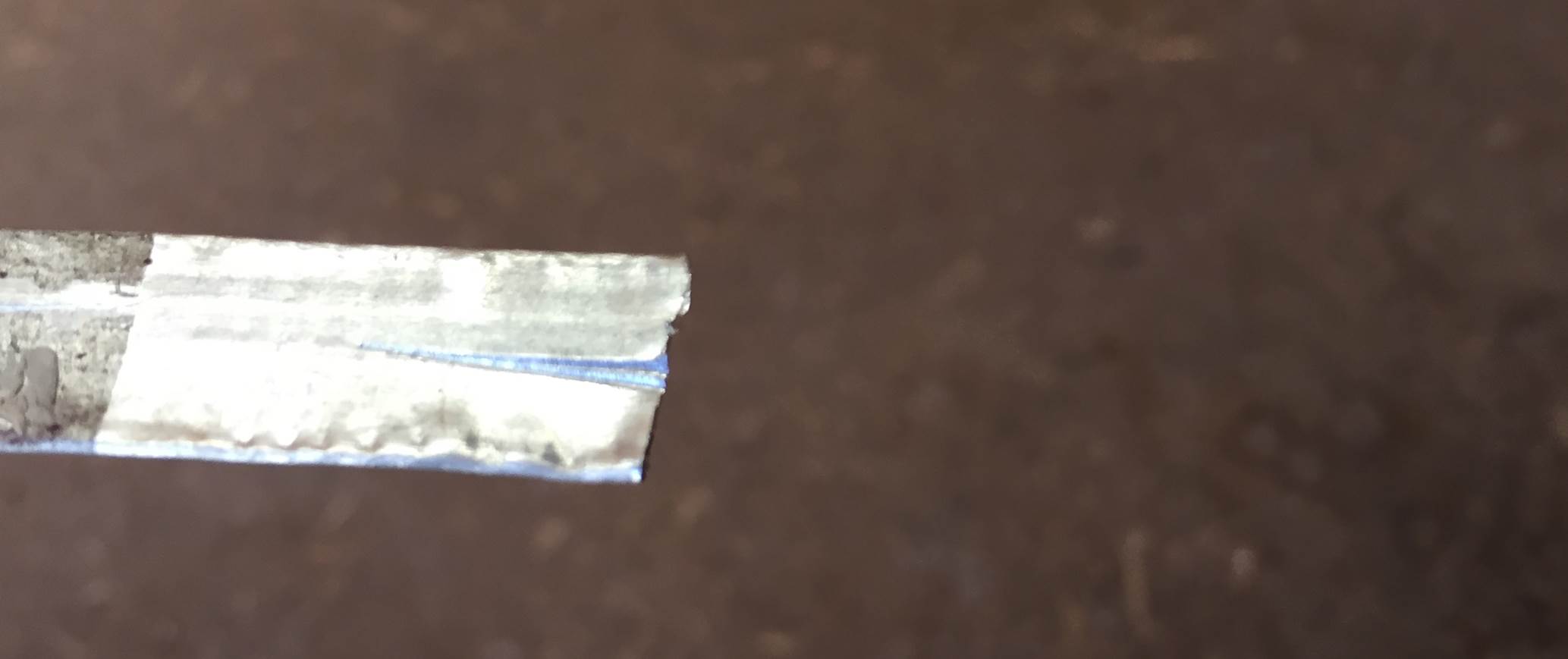 score metal tube to hold graphite rod.jpg