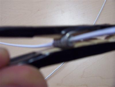 step 9 - (zoom) thread wire through spring hole in slothes pin.jpg