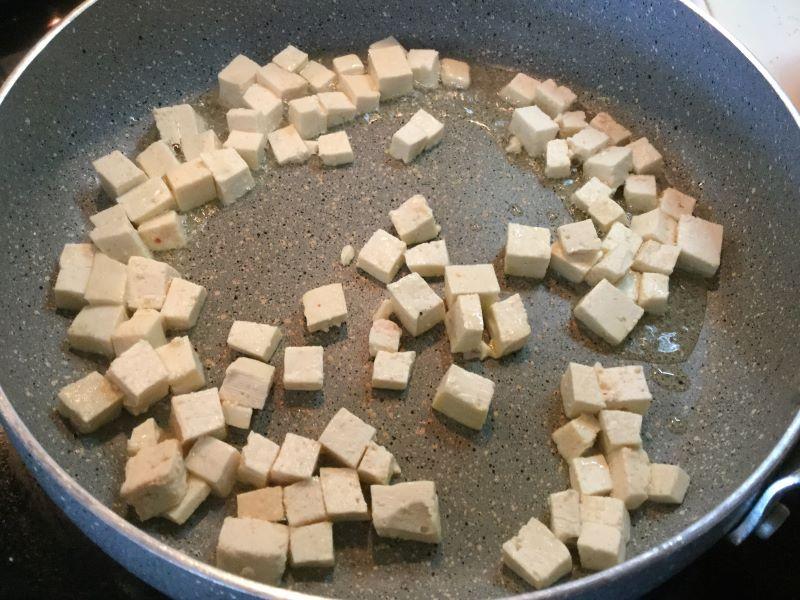 stir frying part of the tofu.JPG