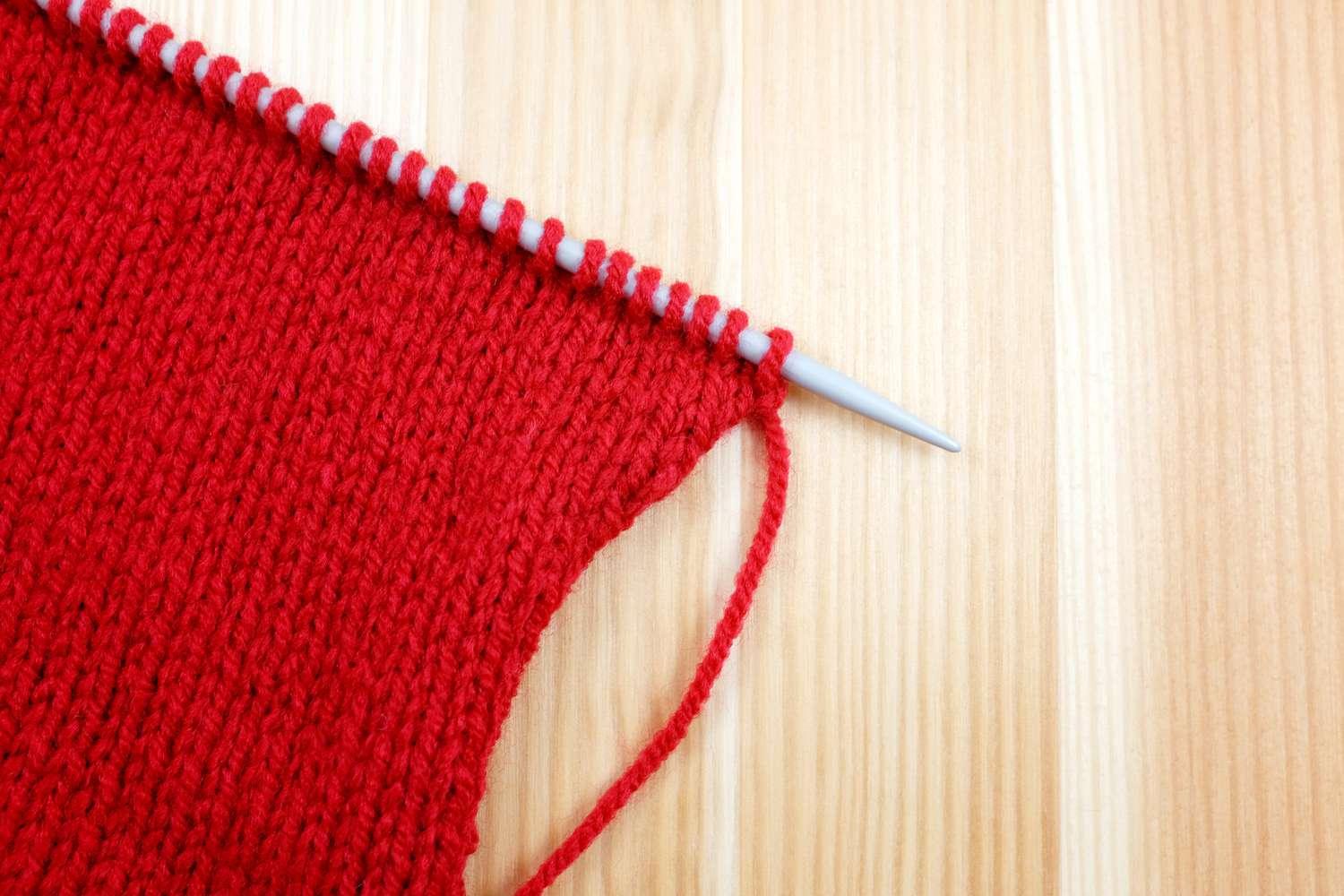 stocking-stitch-in-red-wool-on-a-knitting-needle-185852756-58b40fa690a642f98843819bc1e315aa.jpeg