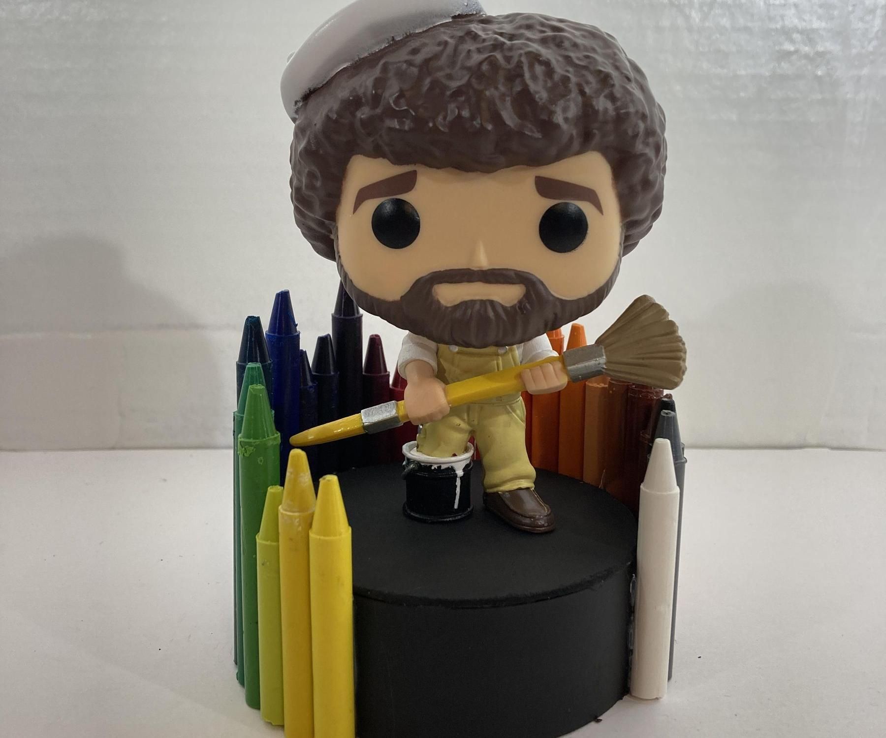 Used Crayons and a Tape Roll Figurine Stand